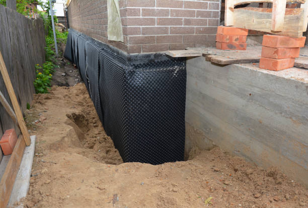 Happy homeowners after waterproofing job in Catlin